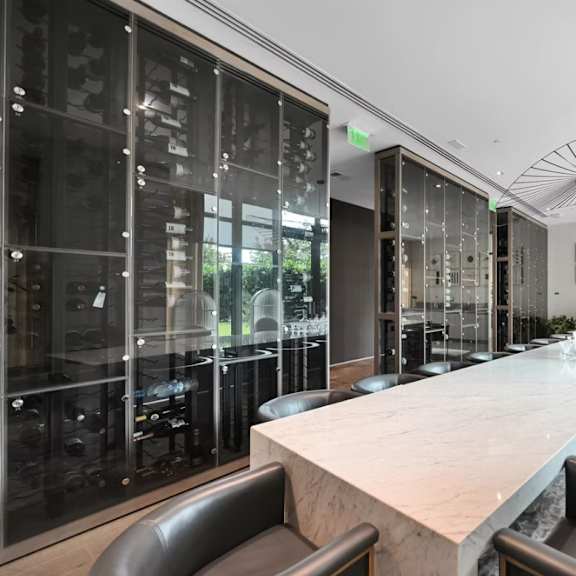 a modern dining room with a long table and black chairs.