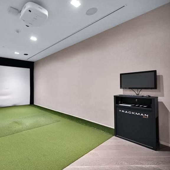 a room with a green carpet and a black box labeled