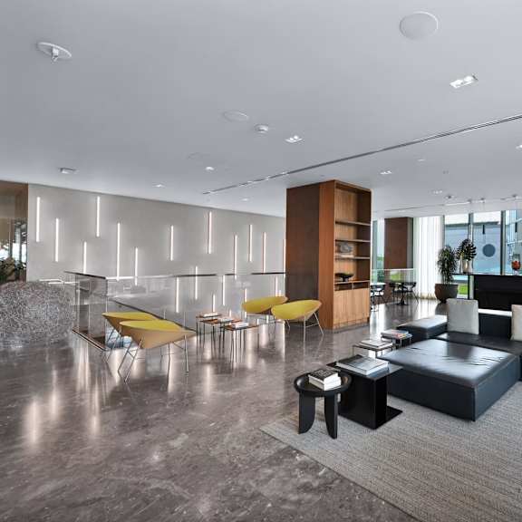 a modern living room with a grey floor and furniture.
