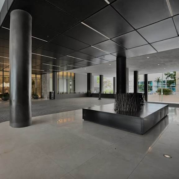 a modern building lobby with a large sculpture in the center.