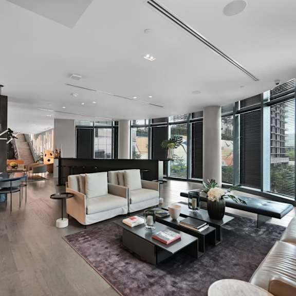 a modern living room with a fireplace and a large window.