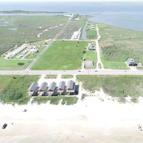 a beachfront property with a row of houses and a parking lot.