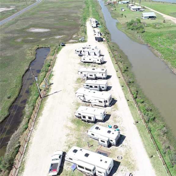 a row of houses are situated along a river.