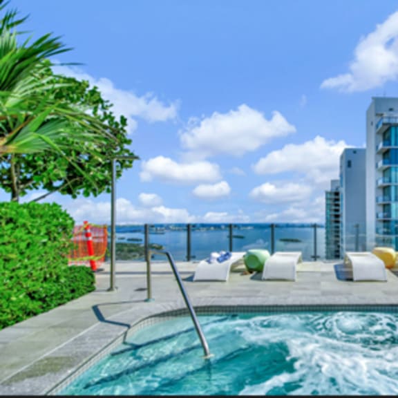 a pool with a slide and a building in the background.