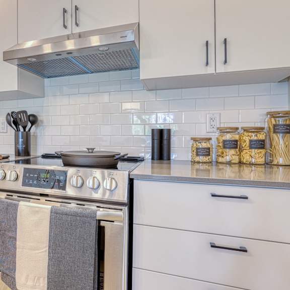 a modern kitchen with a stove top oven and a refrigerator.