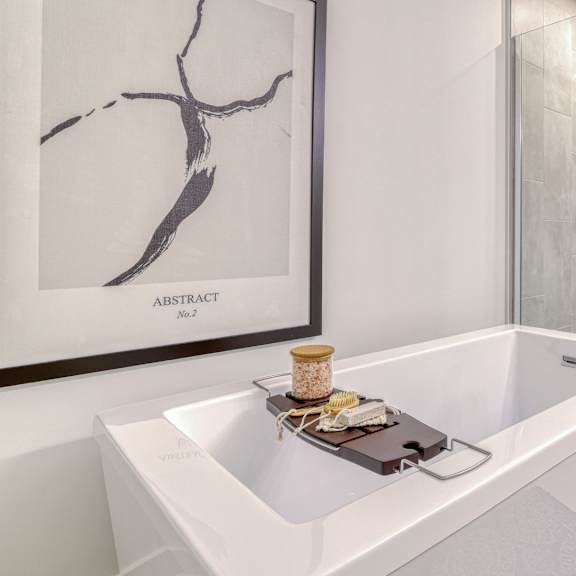 a white bathroom with a marble picture on the wall.