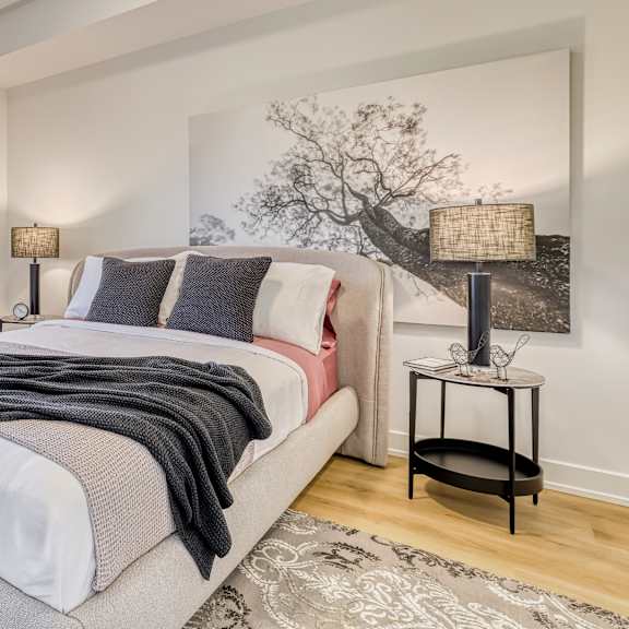 a bedroom with a large bed and a painting on the wall.