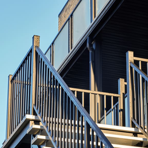 a wooden staircase with a metal railing.