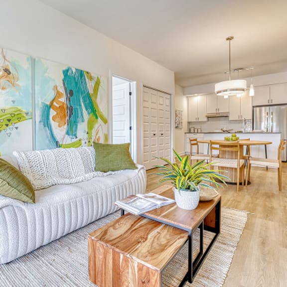 a living room with a white couch and a wooden coffee table.