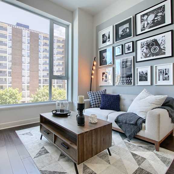 a living room with a couch, coffee table, and pictures on the wall.