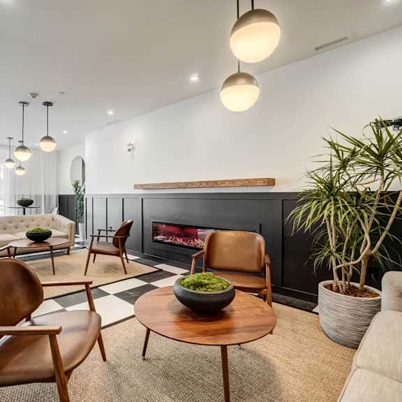 a modern living room with a fireplace and comfortable seating.