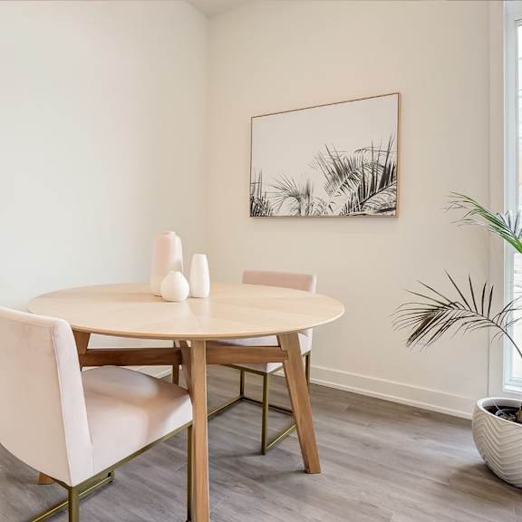 a dining room with a table and chairs.