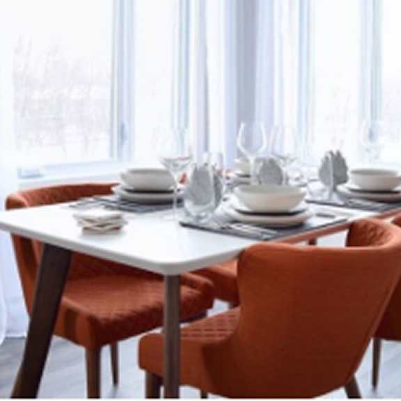 a table with chairs around it is set for a meal.