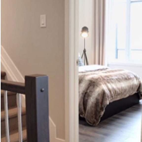 a bedroom with a bed and a chair.