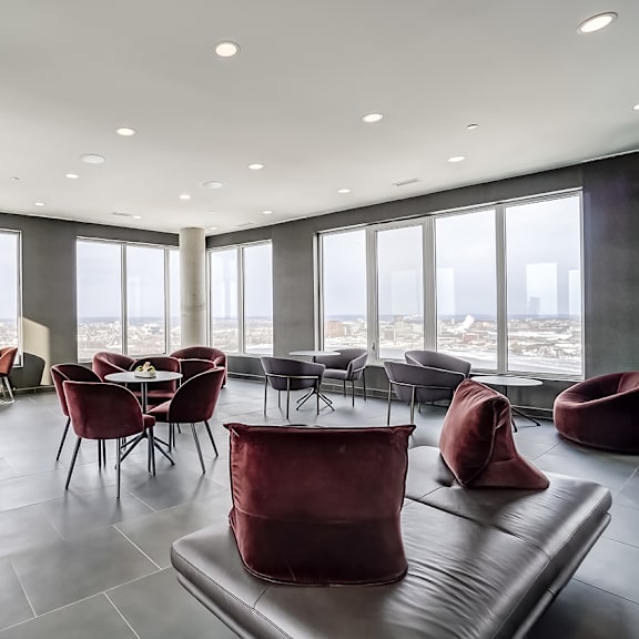 a modern living room with red chairs and a black couch at the dale apartments , ottawa, on, k1y 4y5