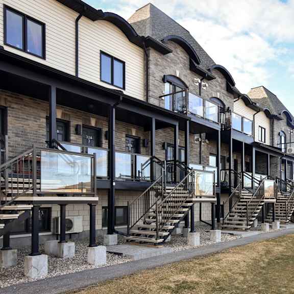 a long row of houses with balconies and staircases.