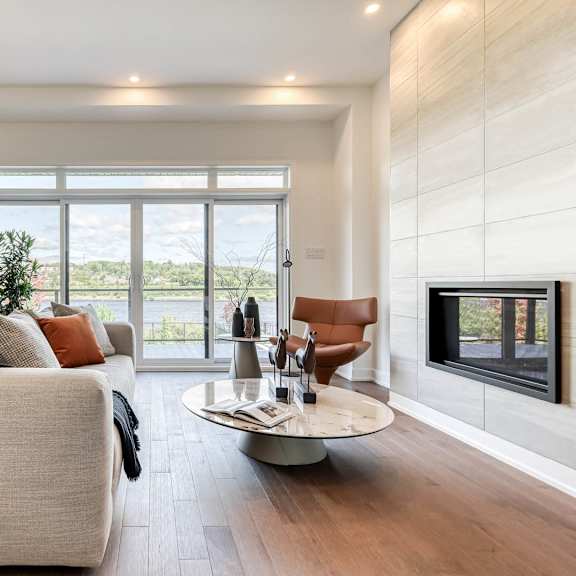 a modern living room with a large couch and a fireplace.