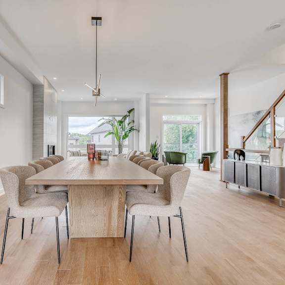 a dining room with a large table and chairs.