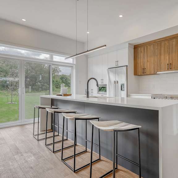 a kitchen with a bar area and a sink.