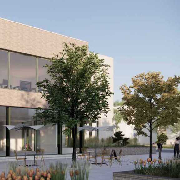 a modern building with a woman standing in the doorway.