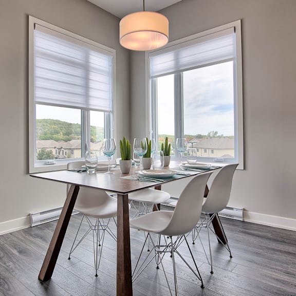 a dining room with a round table and chairs.