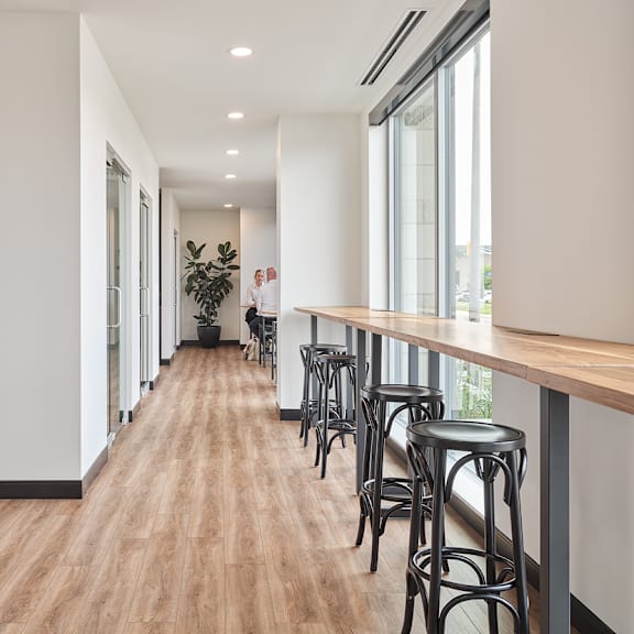 a long hallway with a potted plant on the left and a person standing in the distance at the dale apartments , ottawa, on