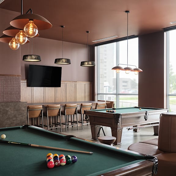 a pool table with a green felt cloth and a television mounted on the wall at the dale apartments , ontario, k1y 4y5