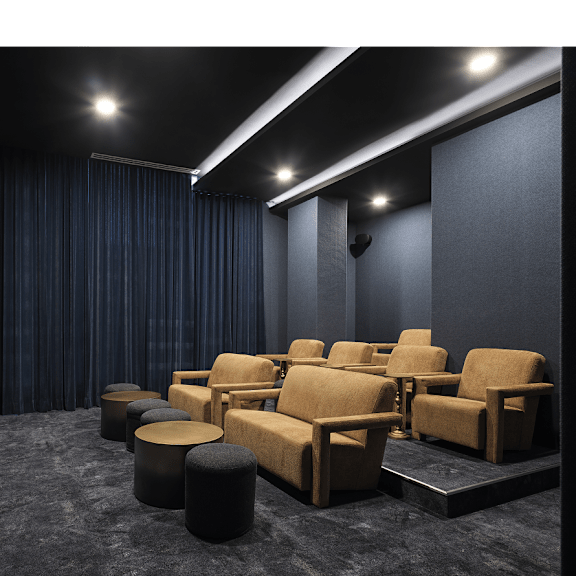 a dark cinema room with rows of seats and a screen on the left at the dale apartments , ottawa, on