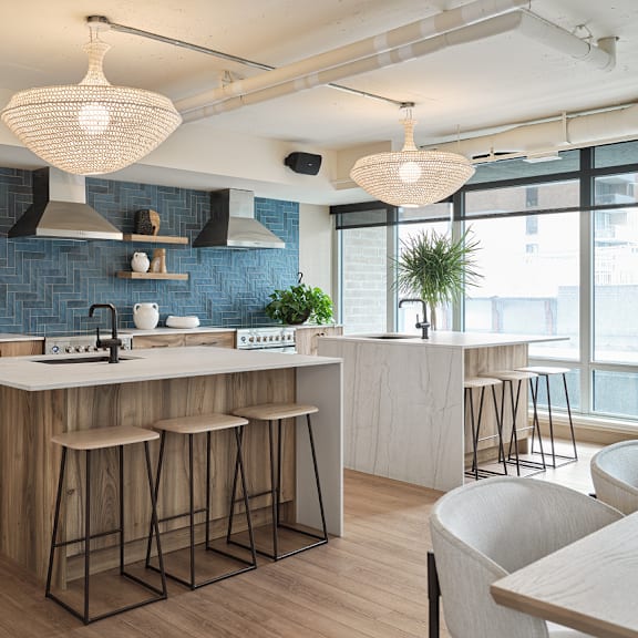 a modern kitchen with a large island and bar stools at the dale apartments , ottawa, k1y 4y5