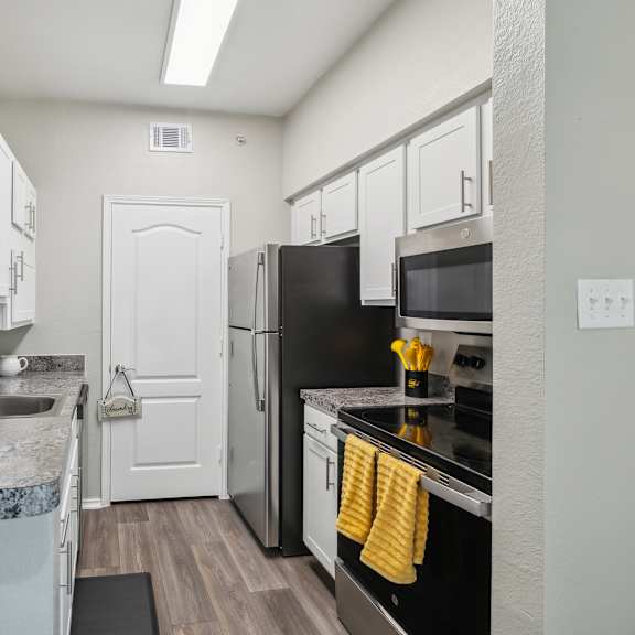 a kitchen with a black refrigerator and stove.