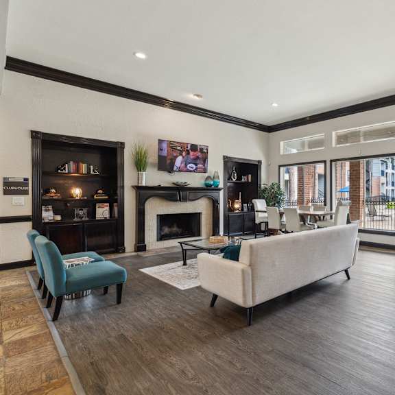 a common room with a fireplace, tv, and a couch.