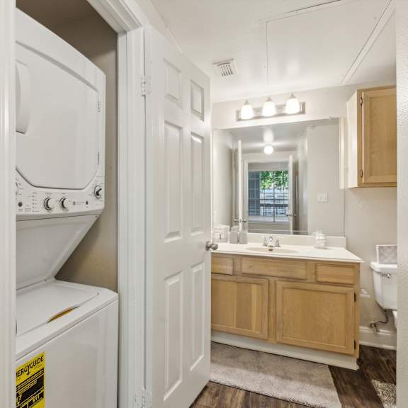 a white washer and dryer are in a small laundry room.
