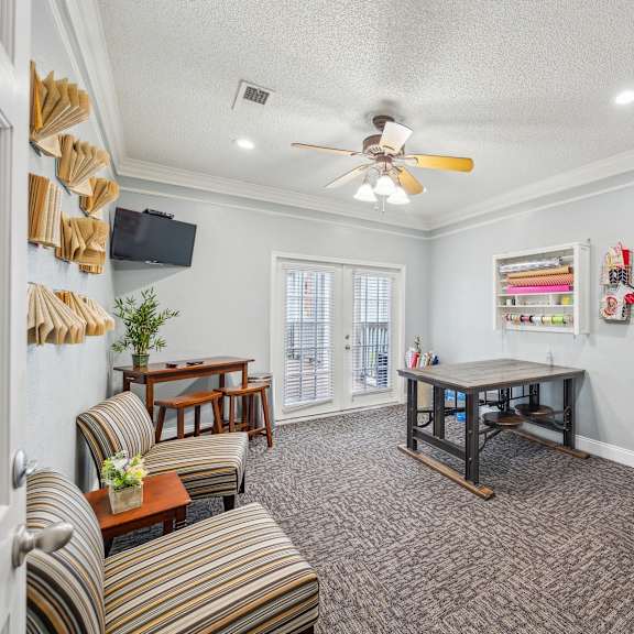 a living room with a striped couch and a wooden coffee table.