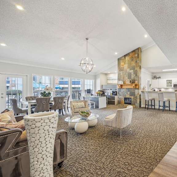 a spacious open-plan living area with a kitchen, dining area, and a large window.