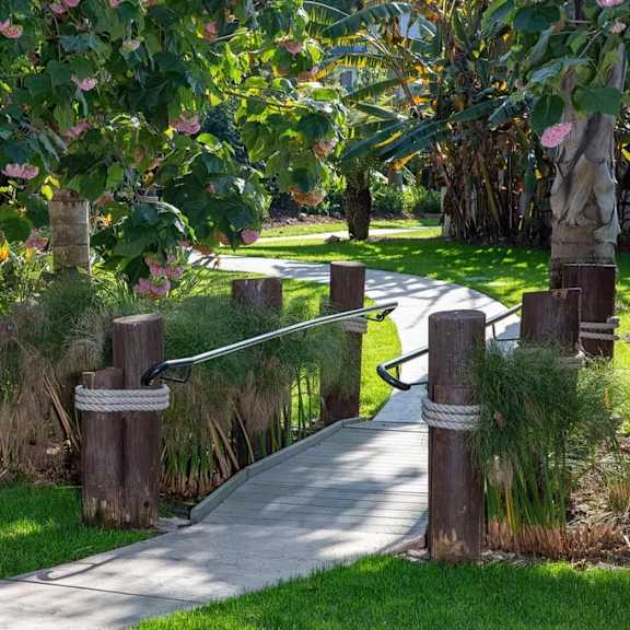 a pathway with a rope barrier and wooden posts.