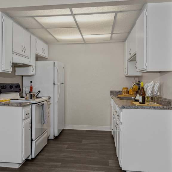 a kitchen with white appliances and cabinets.