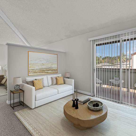 a living room with a white couch and a painting on the wall.