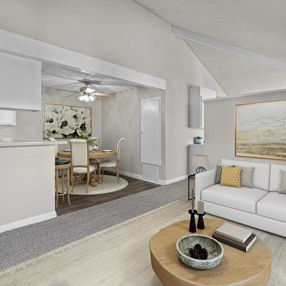 a modern living room with a white couch and a painting on the wall.