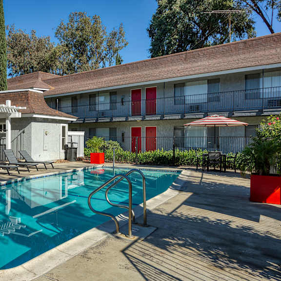 a pool with a slide and a sun shade.