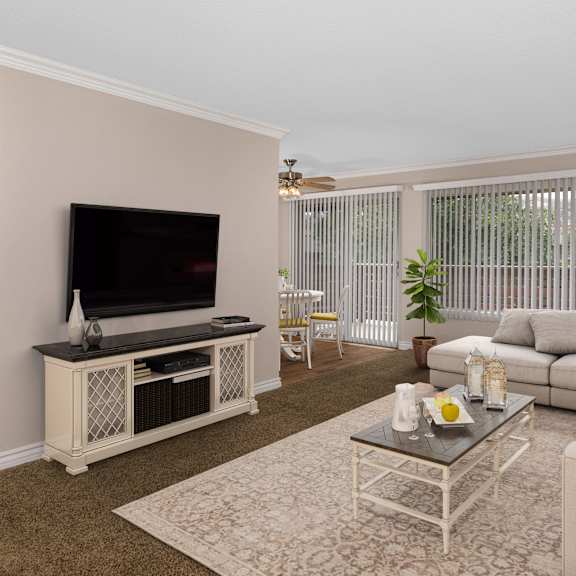 a living room with a television, a sofa, and a coffee table.