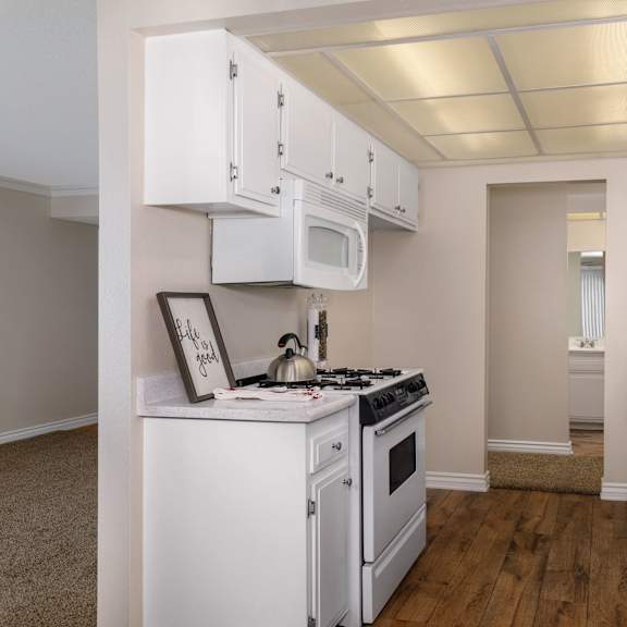 a kitchen with white appliances and cabinets.
