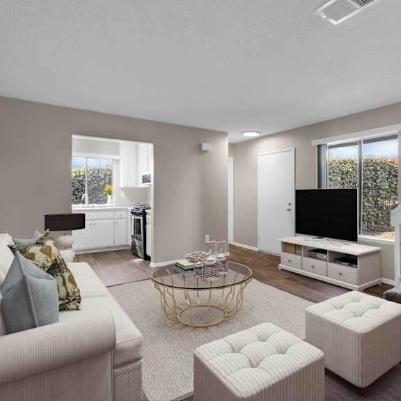 a living room with a couch, a coffee table, and a staircase.