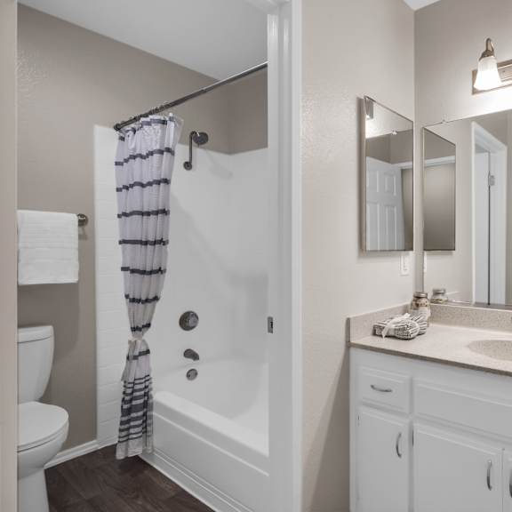 a bathroom with a white sink and a white toilet.