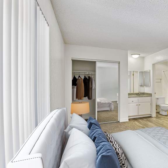 a white living room with a couch and a mirror.