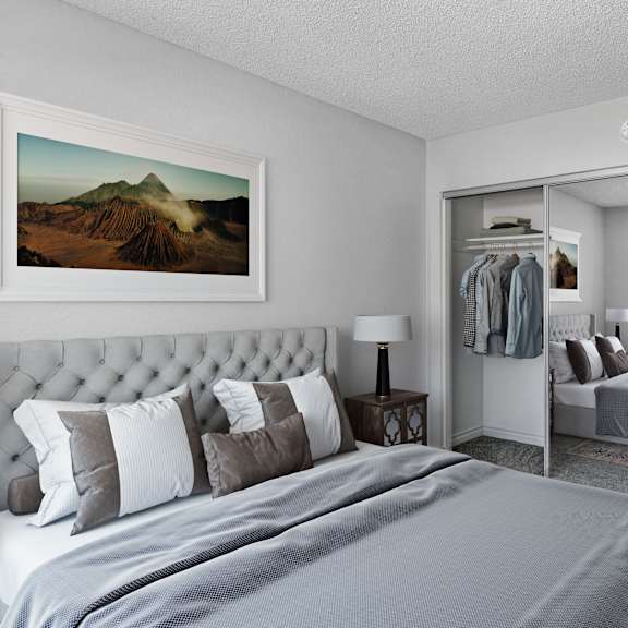 a bedroom with a large bed and a painting of a mountain on the wall.