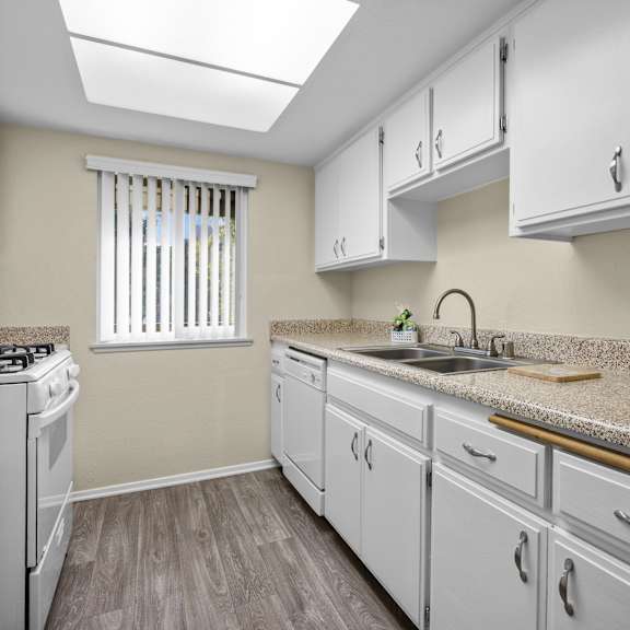a kitchen with white appliances and cabinets.