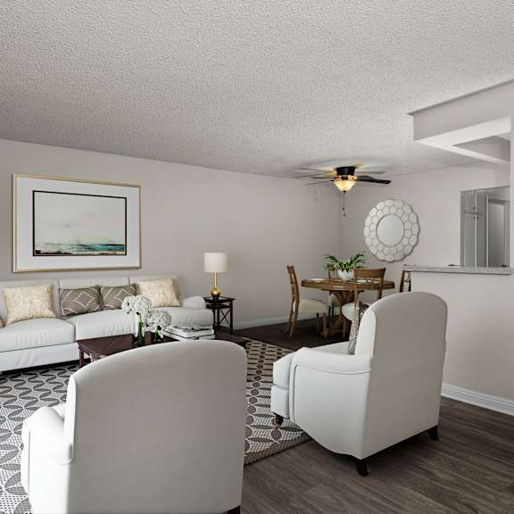 a living room with a white couch, two white chairs, and a painting on the wall.