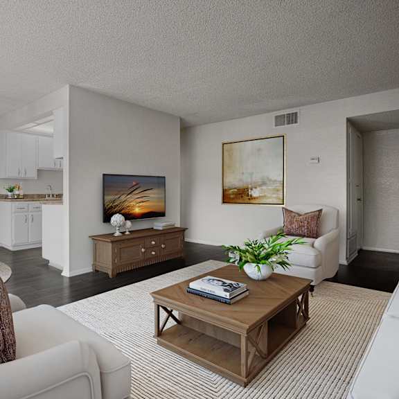 a living room with a white couch and a wooden coffee table.
