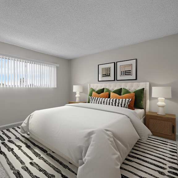 a bedroom with a large bed, a potted plant, and a striped rug.