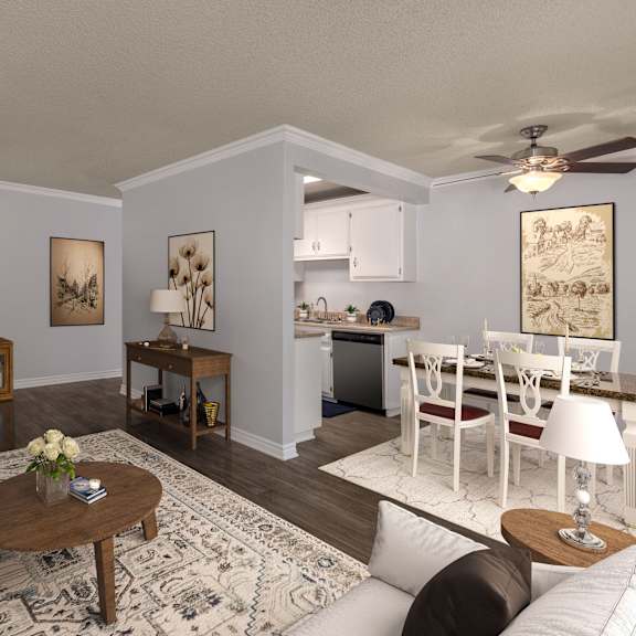 a living room with a white couch, a coffee table, and a television.